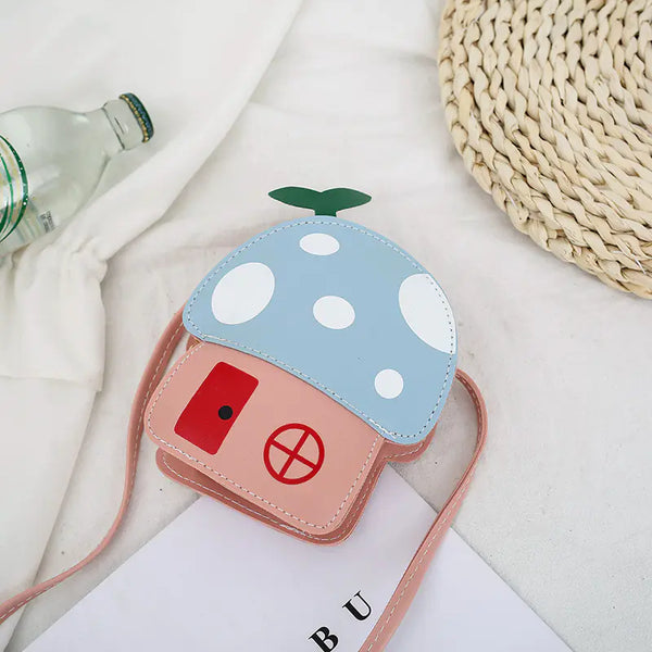 Mushroom-shaped pouch with a strap on a light surface