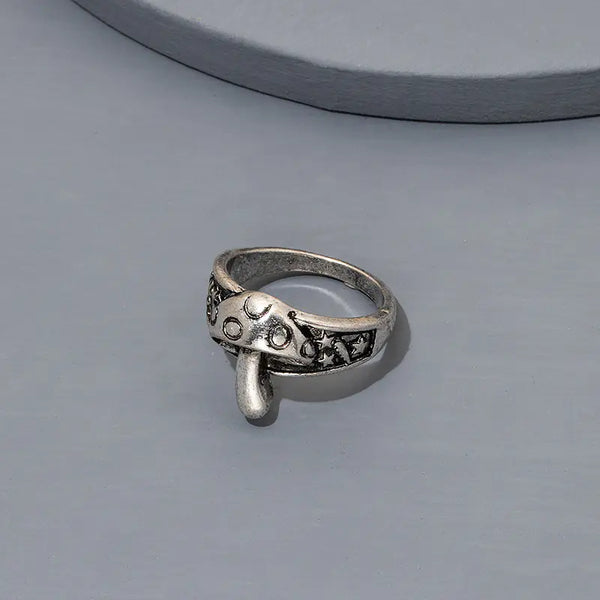 Silver ring with decorative design on a gray background