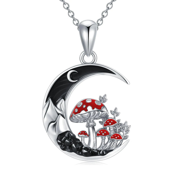 Silver necklace with a moon design and red mushroom pendant on a white background