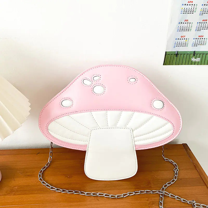Pink and white mushroom-shaped lamp on a wooden surface with a calendar in the background.