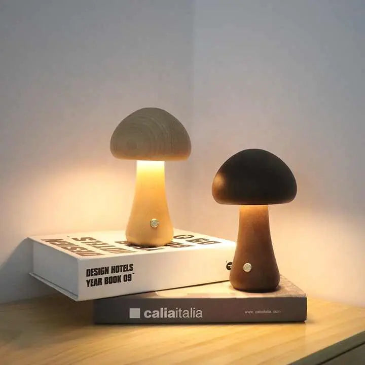 Two mushroom-shaped lamps on books with a soft glow against a neutral background