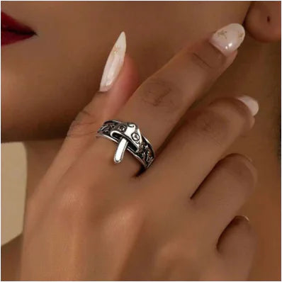 Silver ring on a finger with a blurred background