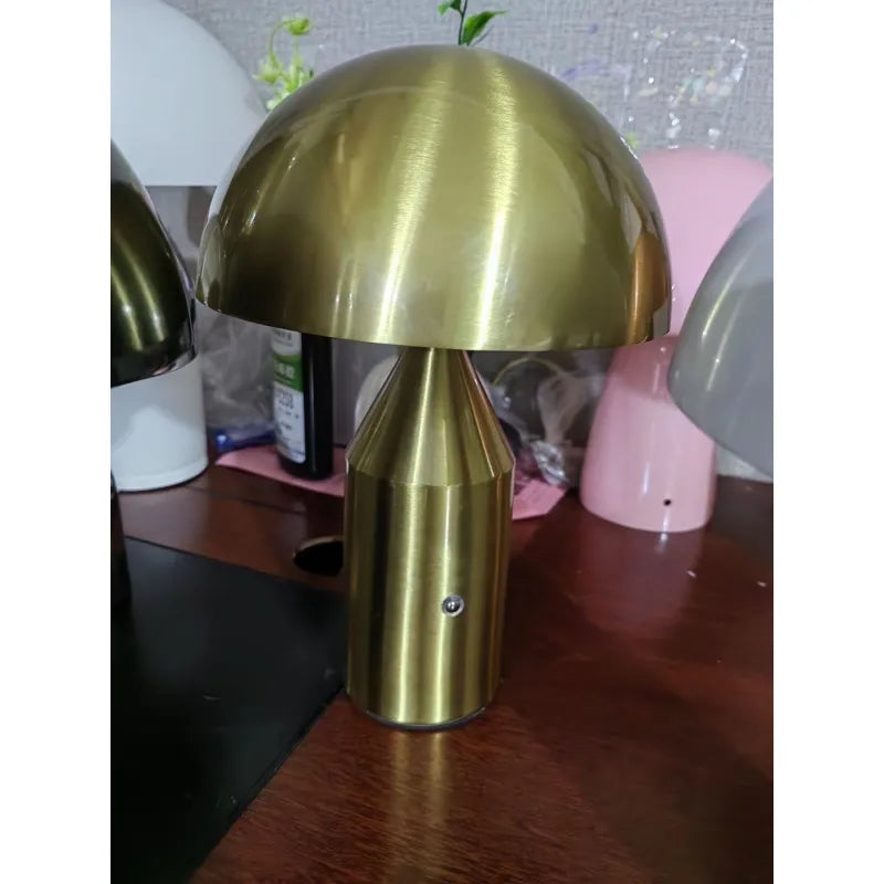 Gold table lamp on a wooden surface with blurred background