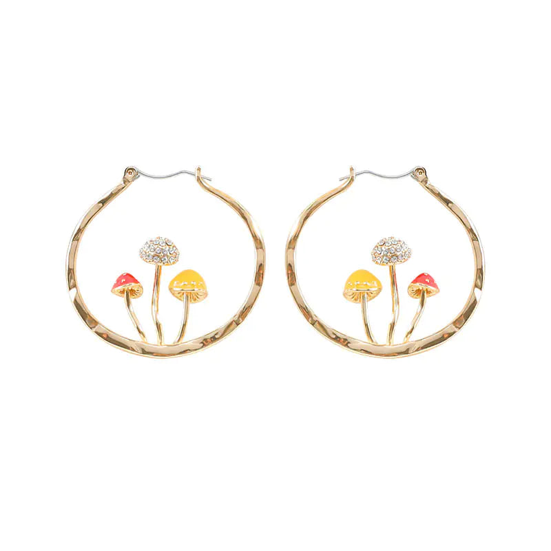 Gold hoop earrings with mushroom designs on a white background
