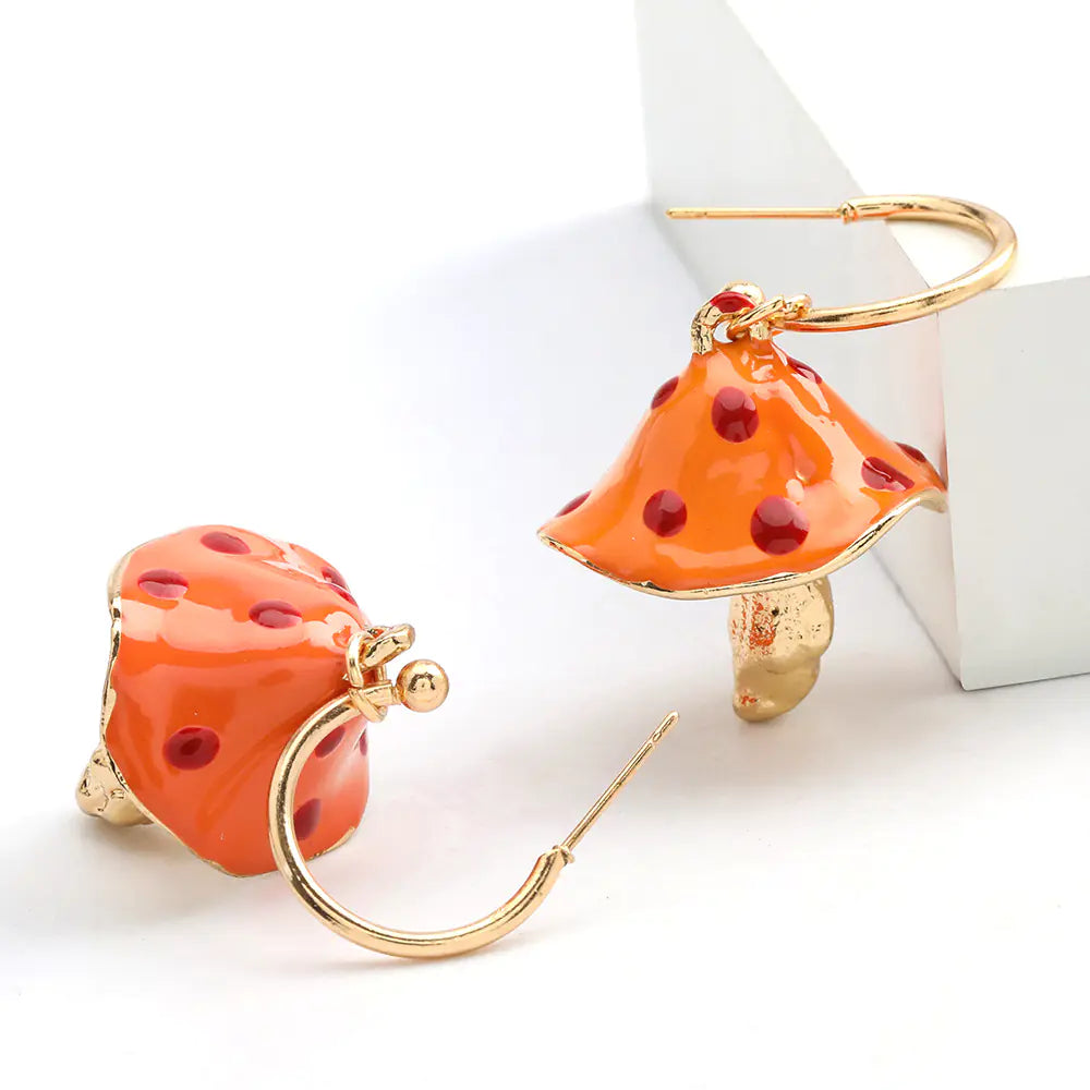 Orange mushroom-shaped earrings with gold accents on a white background