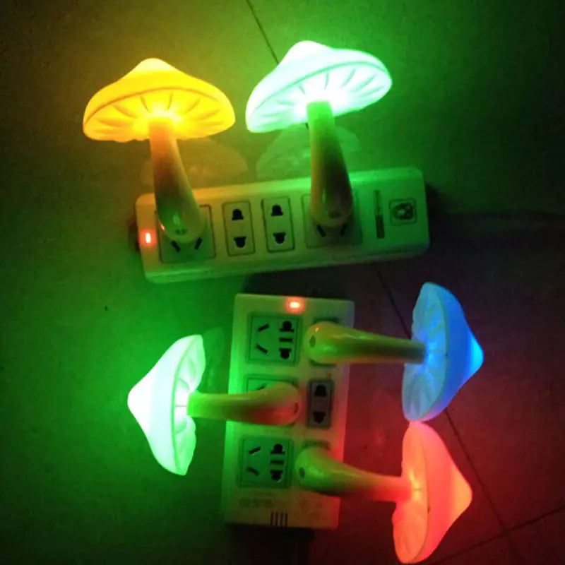 Mushroom-shaped night lights attached to electrical outlets on a green surface.