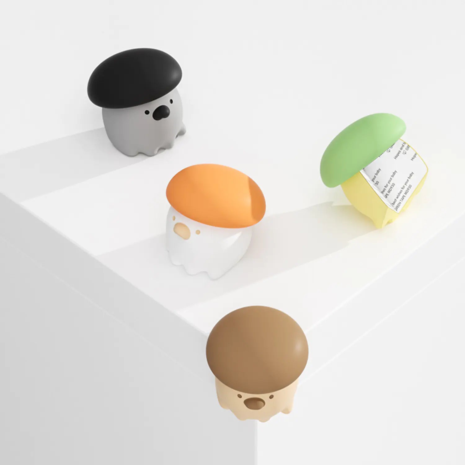 Set of small, colorful mushroom-shaped containers on a white surface
