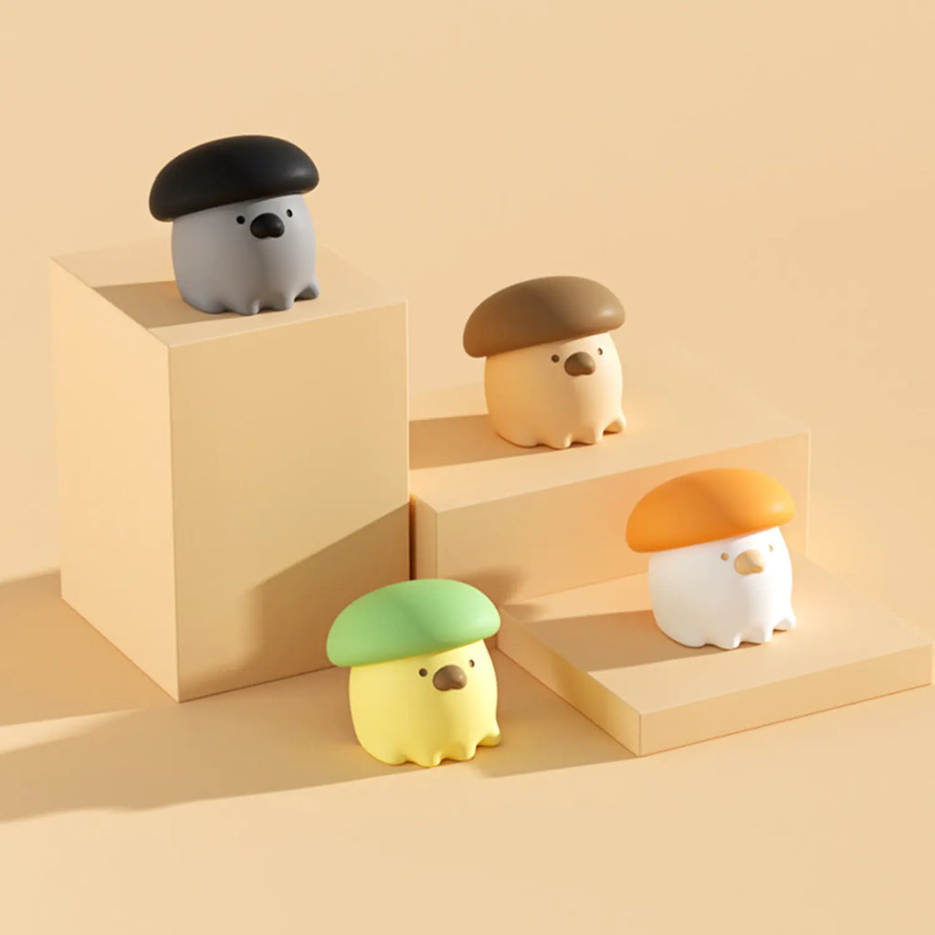 Four small animal figurines with colorful hats on a beige geometric background
