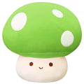 Plush toy shaped like a green mushroom with a smiling face on a white background