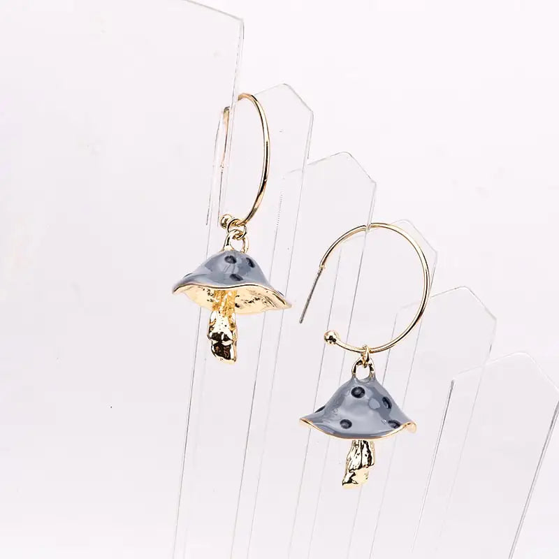 Pair of gold and silver earrings on a white background