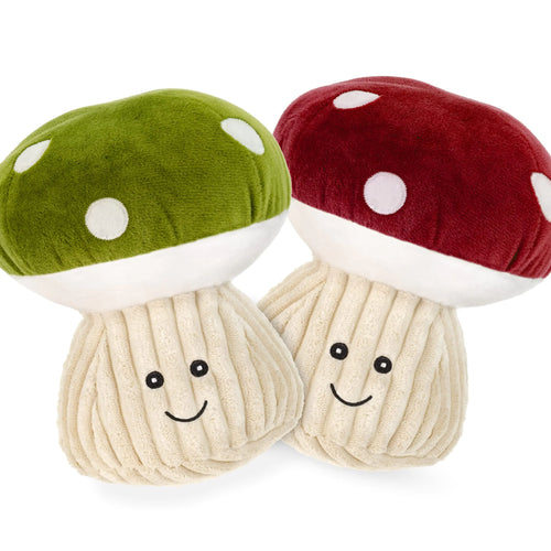 Two 7-inch plush mushroom dog toys with embroidered smiling faces, one green cap and one red cap, on a white background