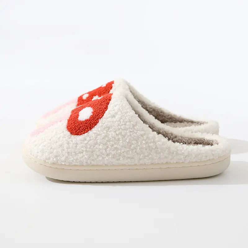 White slippers with a red heart design on a white background