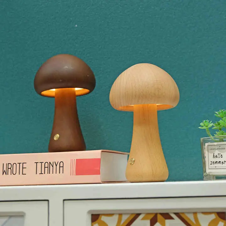 Two mushroom-shaped lamps on a surface with a teal wall in the background.