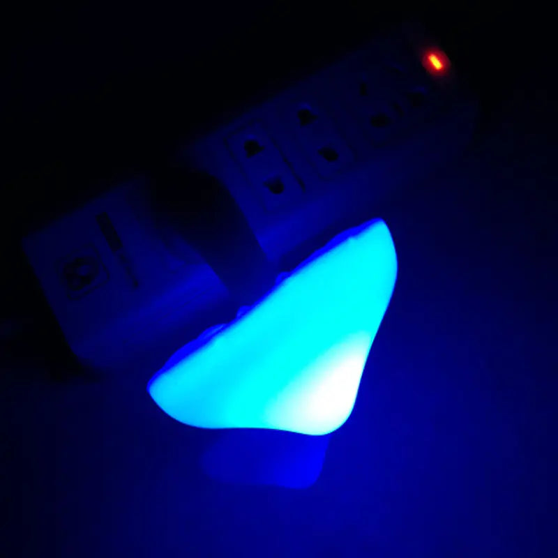 Blue glowing light bulb on a dark background