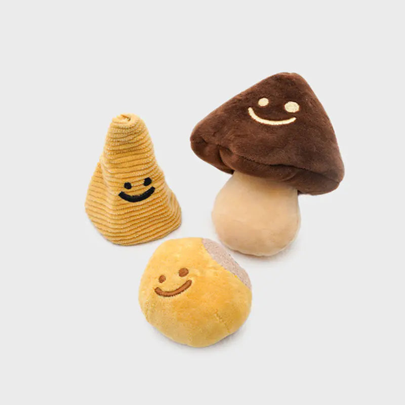 Three plush mushroom toys with smiling faces on a light gray background