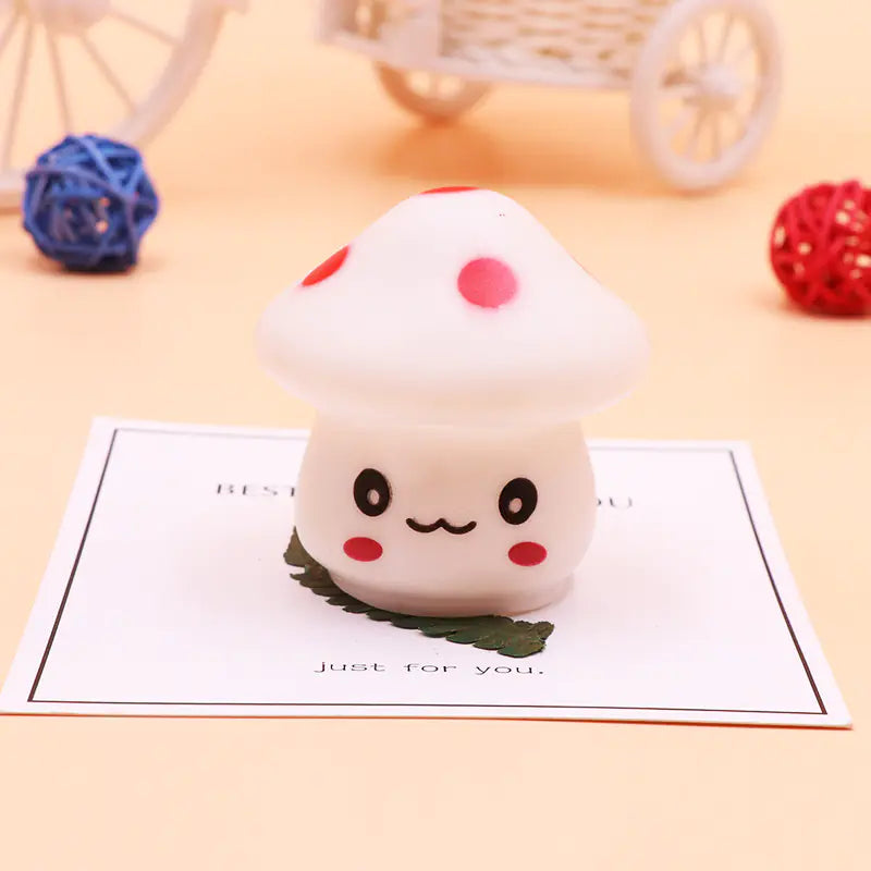 Squishy toy shaped like a cute character on a piece of paper with decorative elements in the background.
