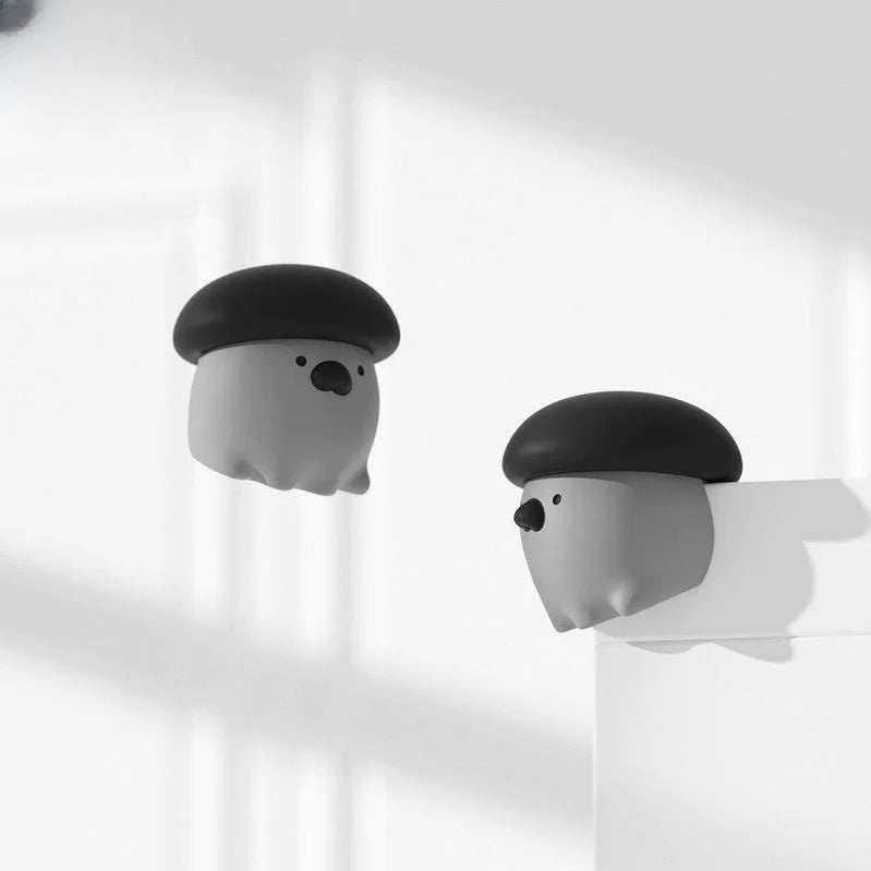 Two cartoonish ghost figures with black hats on a white background