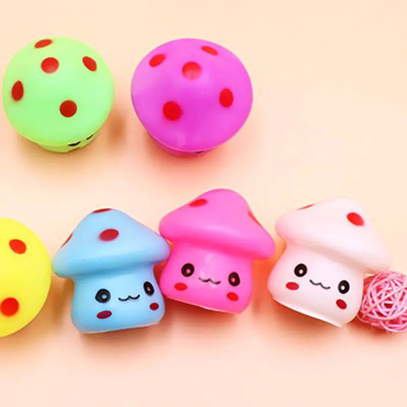 Colorful mushroom-shaped erasers with smiling faces on a light pink background