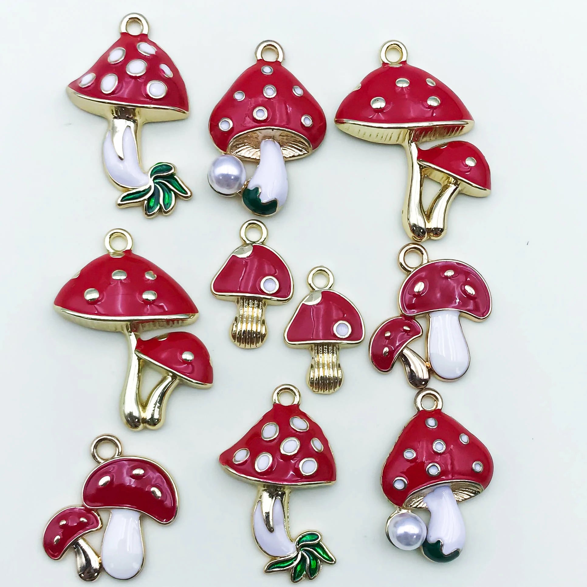 Red mushroom-shaped charms with white spots on a white background
