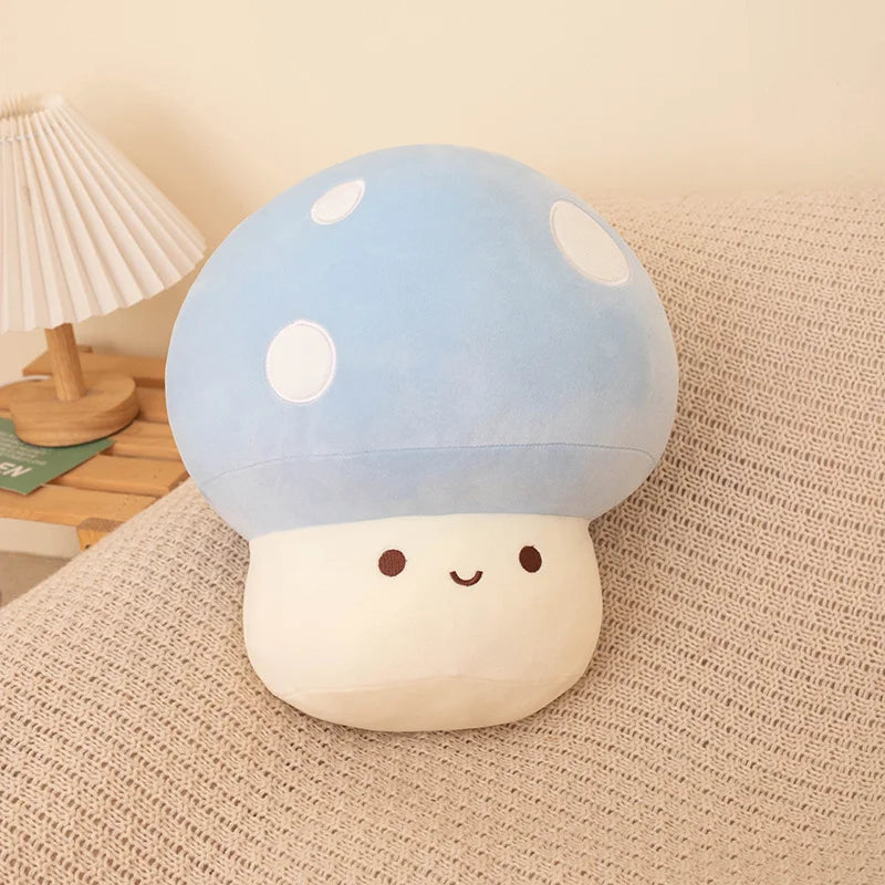 Cute plush mushroom toy with a blue cap and white spots on a beige surface.