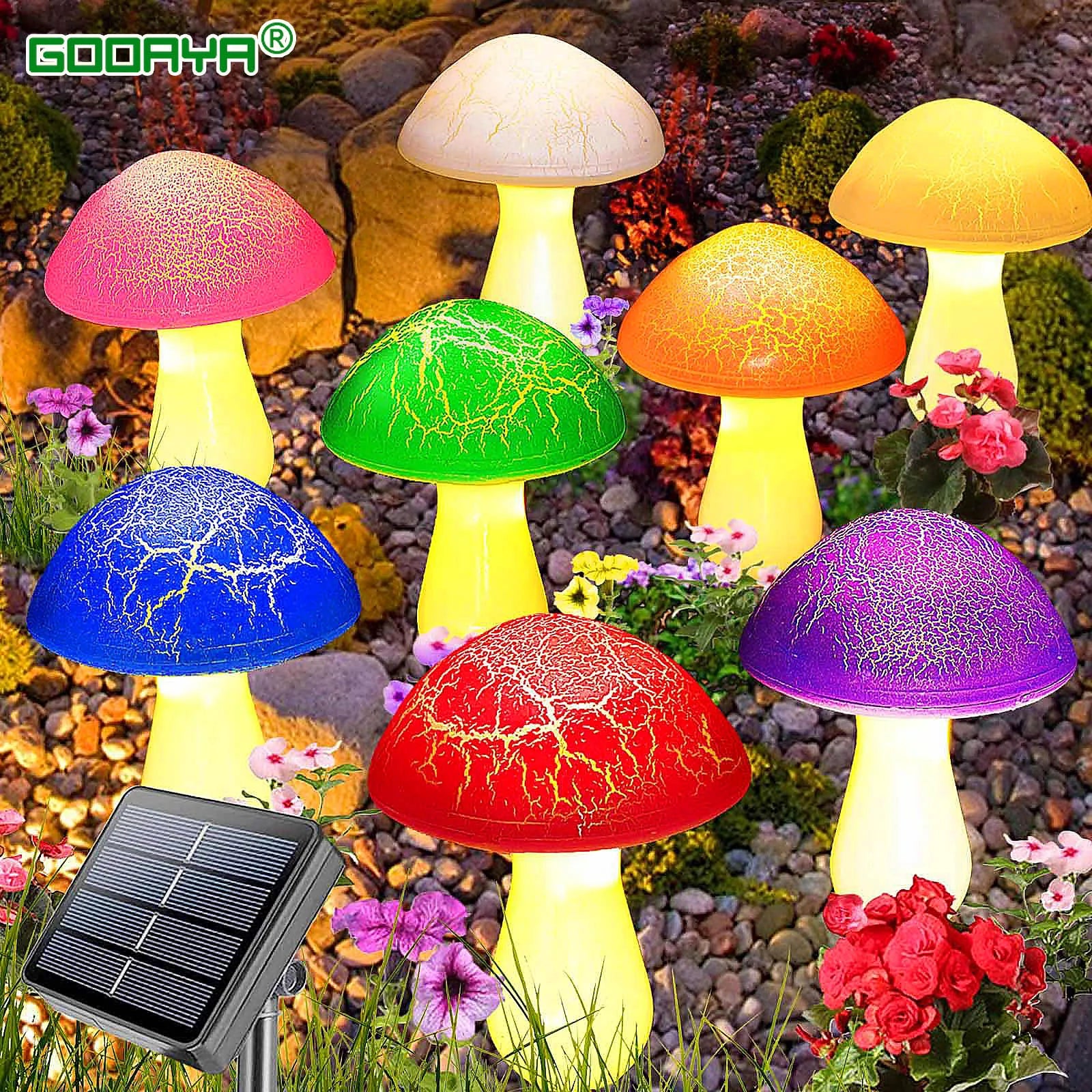 Colorful mushroom-shaped lamps with a solar panel on a garden background