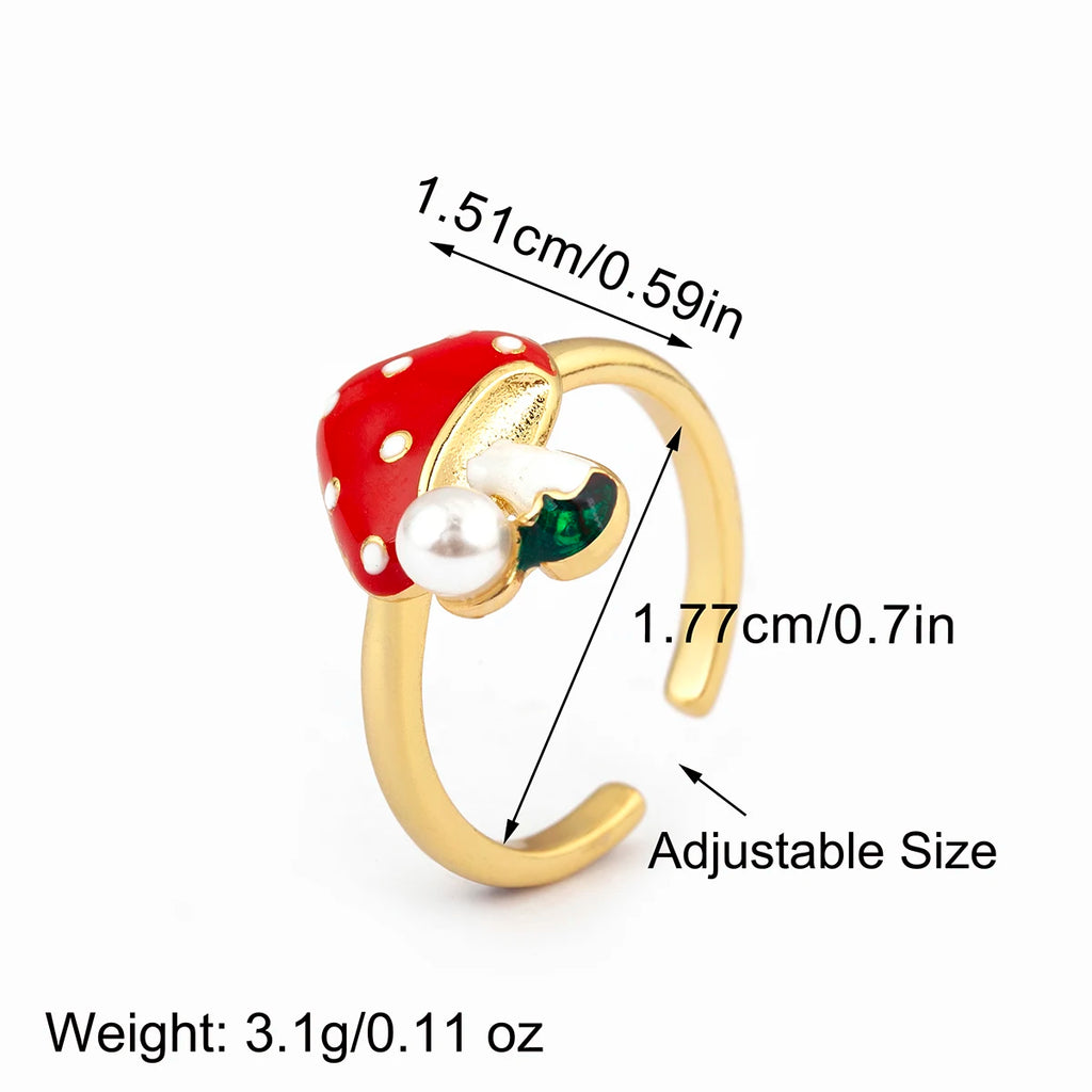 Ring with red mushroom and pearl design, showing measurements and weight on a white background