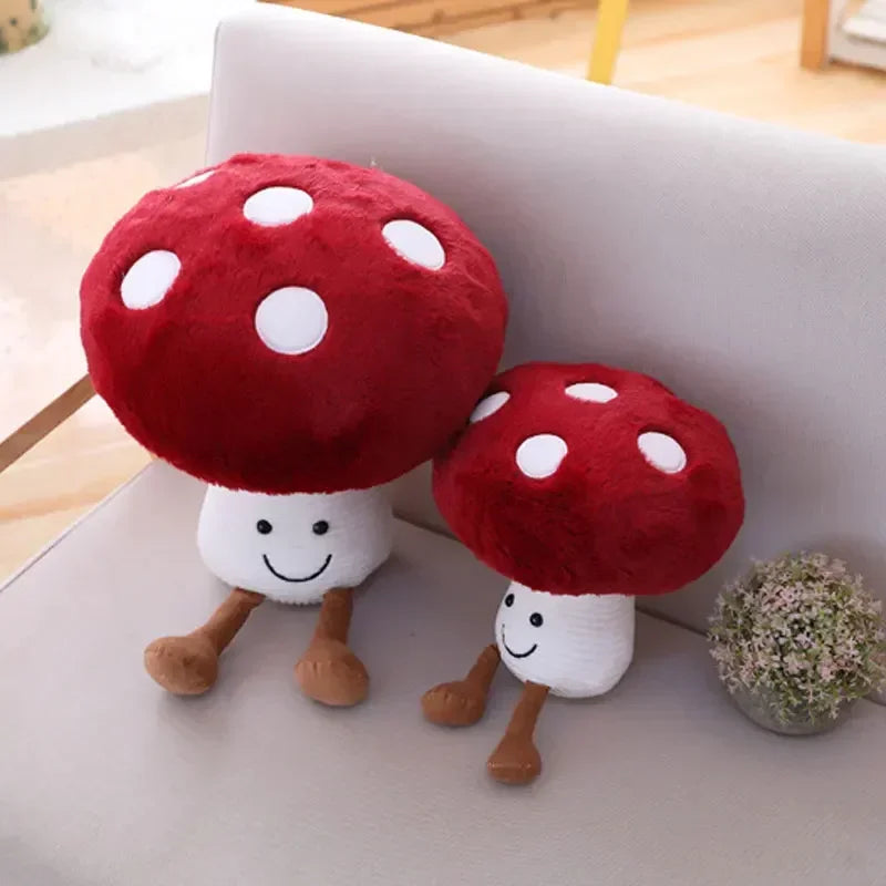 Two red and white mushroom-shaped plush toys on a light-colored surface.