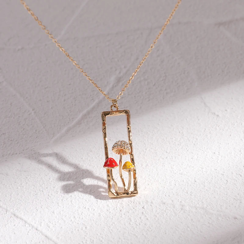 Necklace with a pendant featuring mushrooms on a light gray background