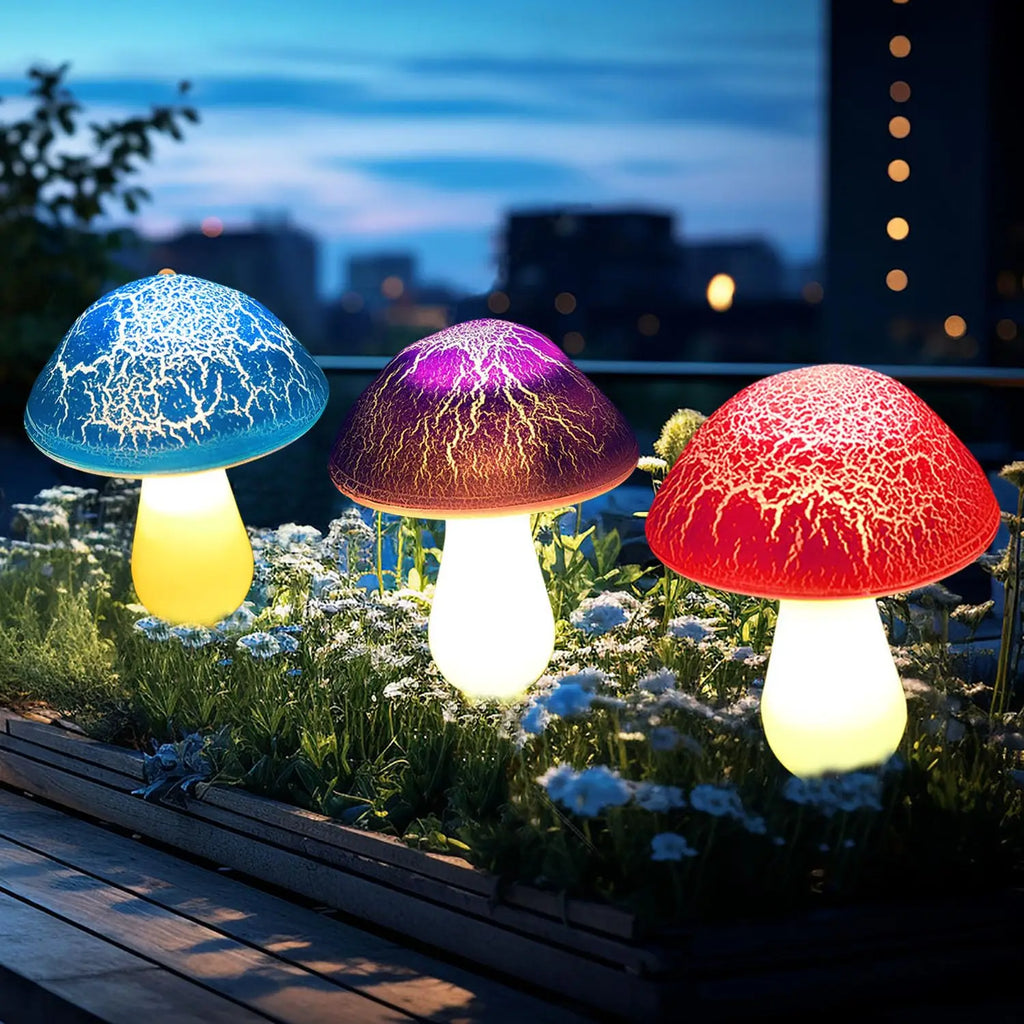 Three colorful mushroom-shaped lights on a garden bed with a cityscape in the background.