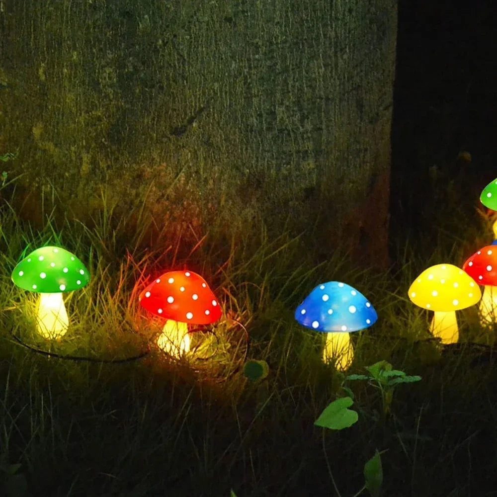 Colorful mushroom-shaped lights on grass at night