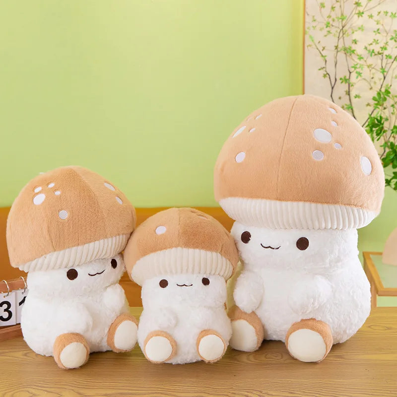 Three plush mushroom toys on a wooden surface with a green wall in the background.