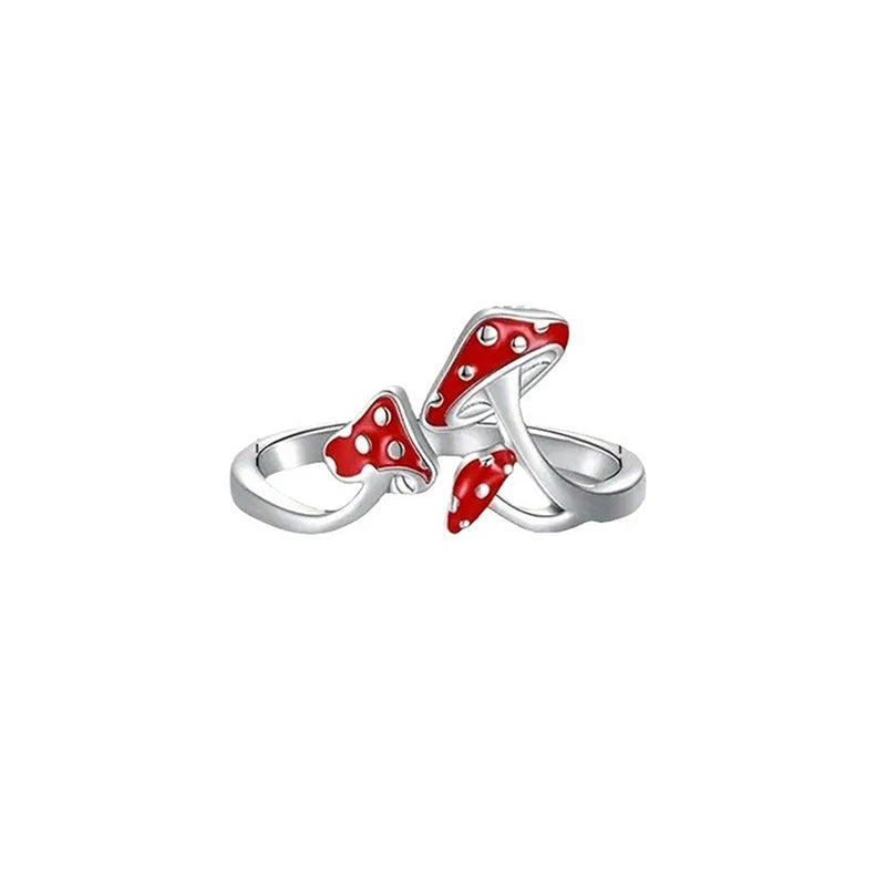 Silver ring with red polka dot design on a white background