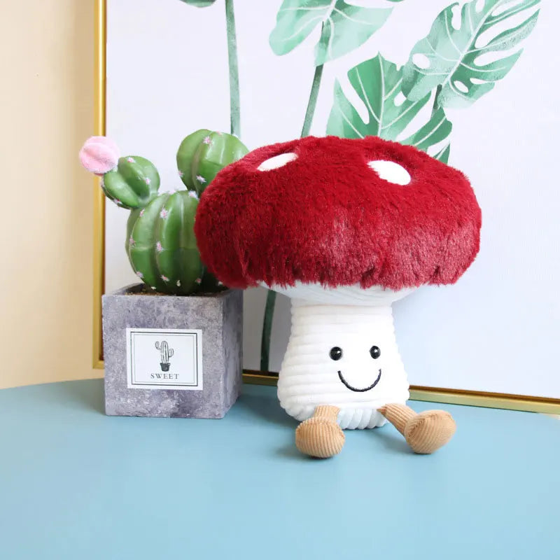 Plush toy mushroom with a happy face on a blue surface, next to a potted plant.