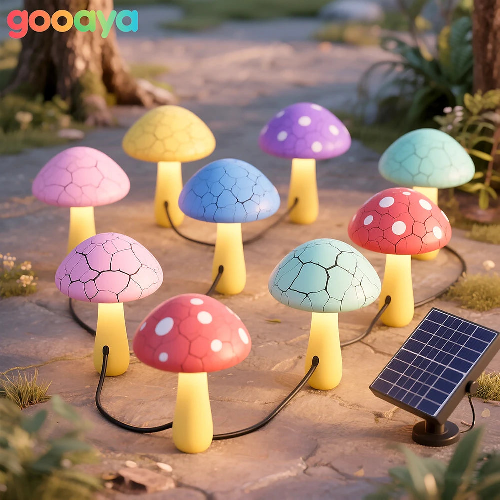 Colorful mushroom-shaped lamps with a solar panel on a garden path.