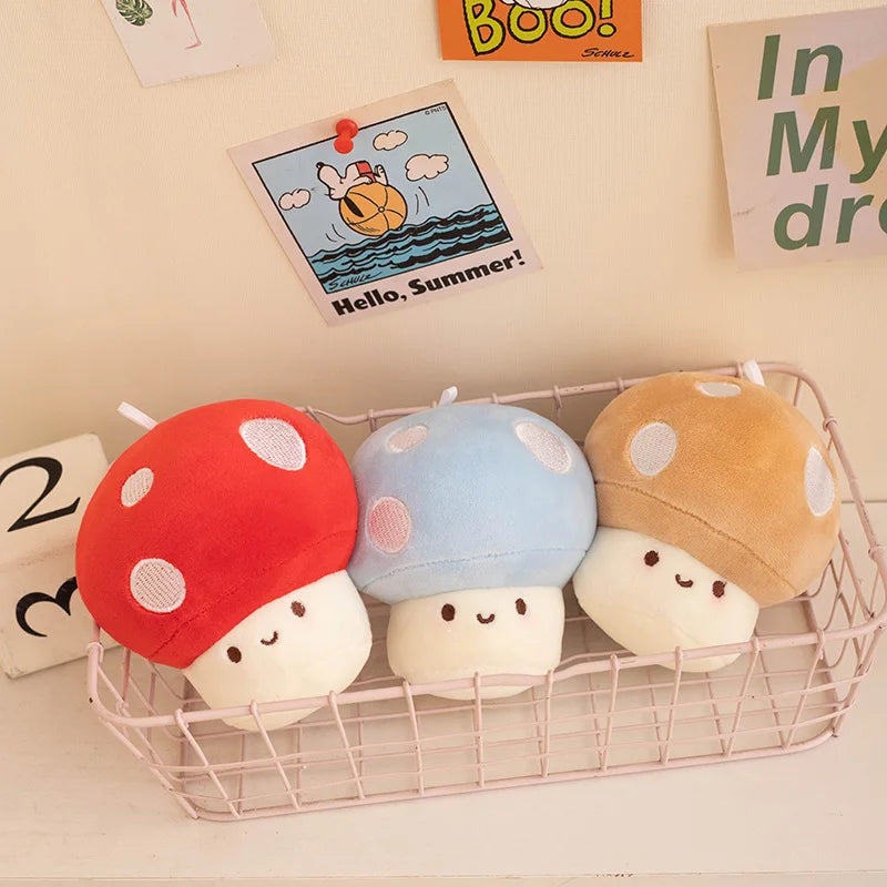 Three colorful mushroom-shaped plush toys in a wire basket with decorative items in the background.