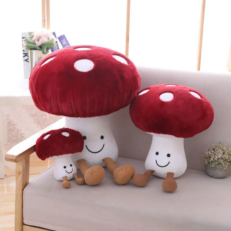 Red and white mushroom-shaped plush toys on a couch