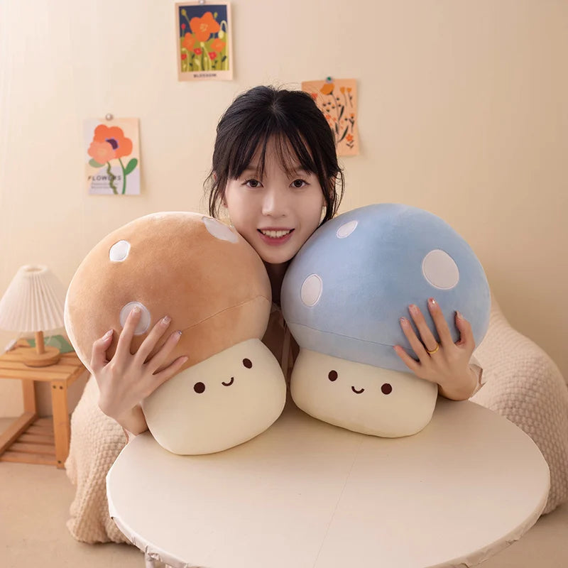 Person holding two plush mushroom toys in a room with decorative elements.