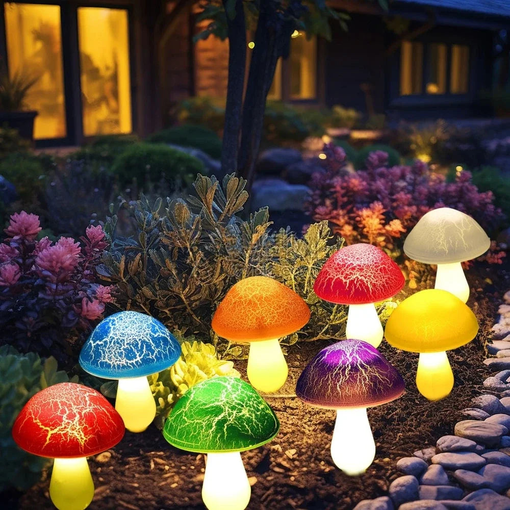 Colorful mushroom-shaped garden lights in a garden setting with a house in the background.