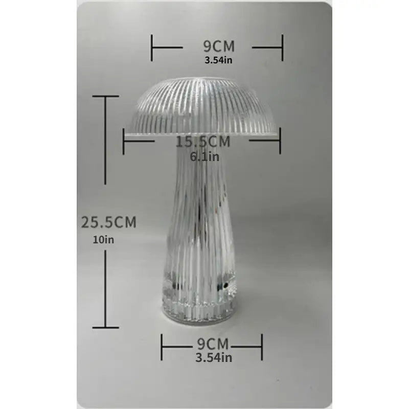 Clear glass mushroom-shaped object with measurements on a gray background