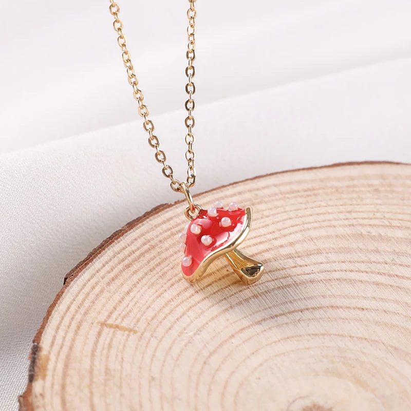 Necklace with a red mushroom pendant on a wooden surface