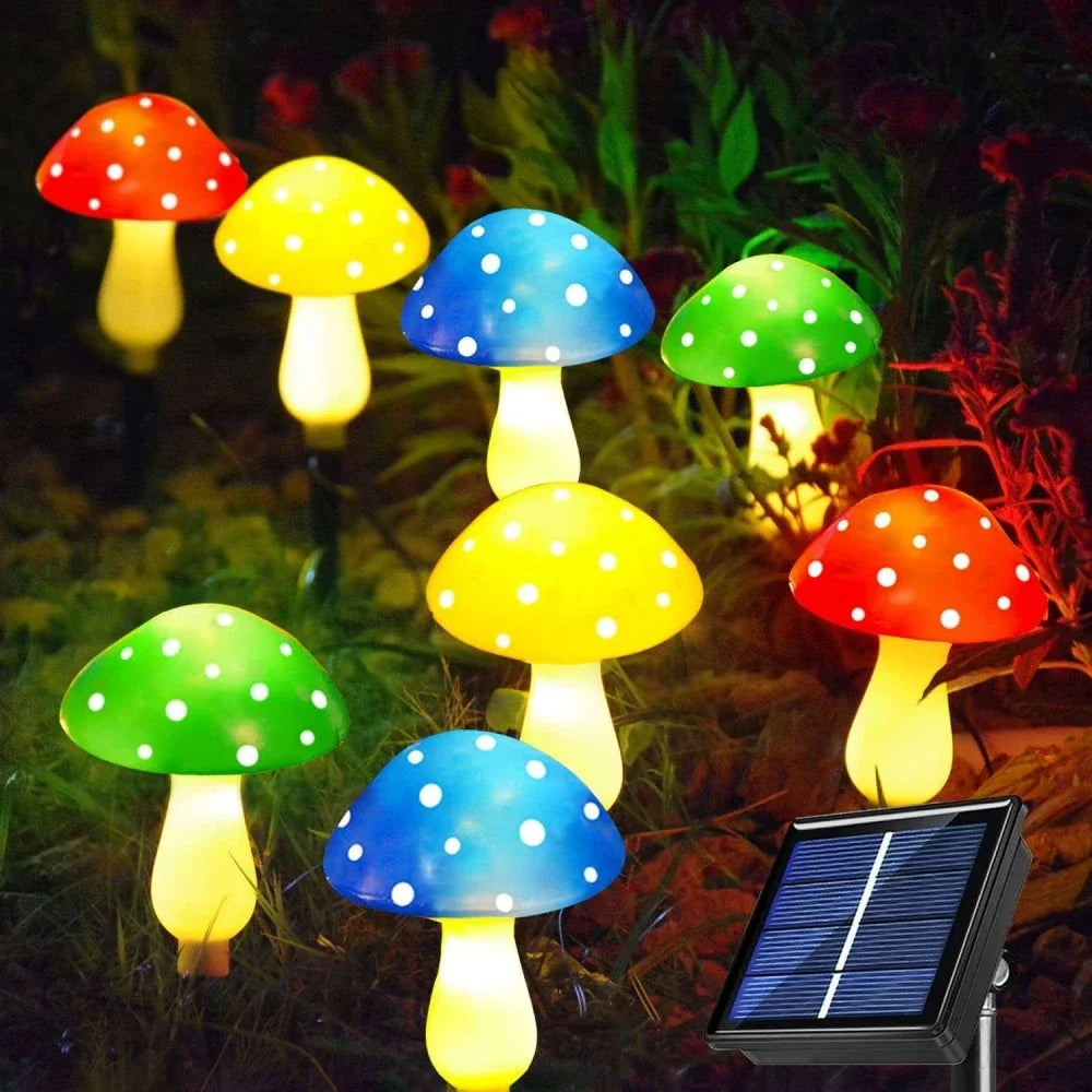 Colorful mushroom-shaped lights with a solar panel on grass