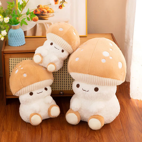 Three plush mushroom toys on a wooden floor with a decorative background.