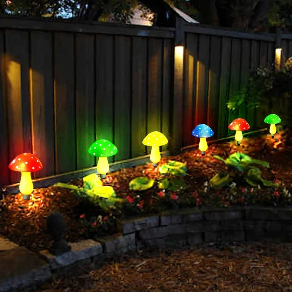 Colorful mushroom-shaped garden lights on a wooden fence background