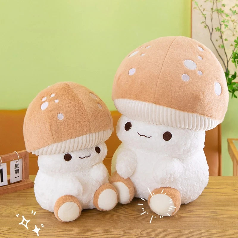 Two cute mushroom-shaped plush toys sitting on a wooden surface with a green wall in the background.