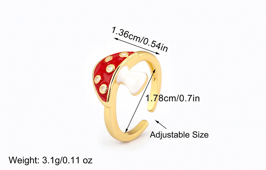 Gold ring with red gemstones and measurements on a white background