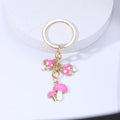 Keychain with pink mushroom and heart charms on a white background