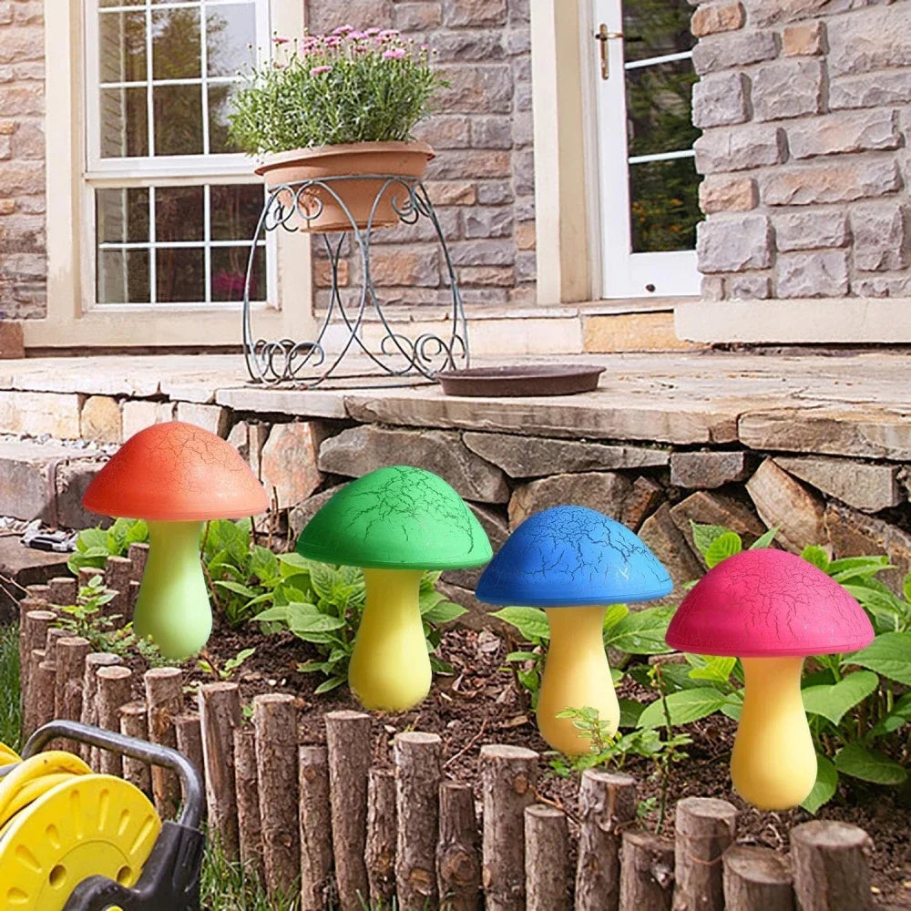 Colorful mushroom-shaped garden lights on a stone patio with a stone wall and window in the background.