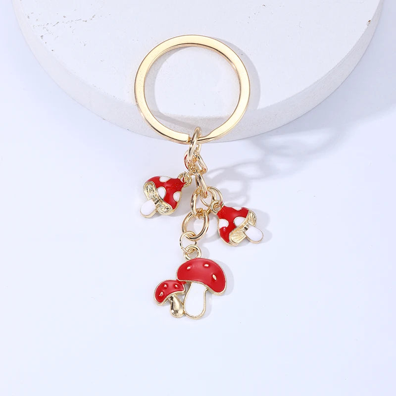 Keychain with red mushroom charms on a white background