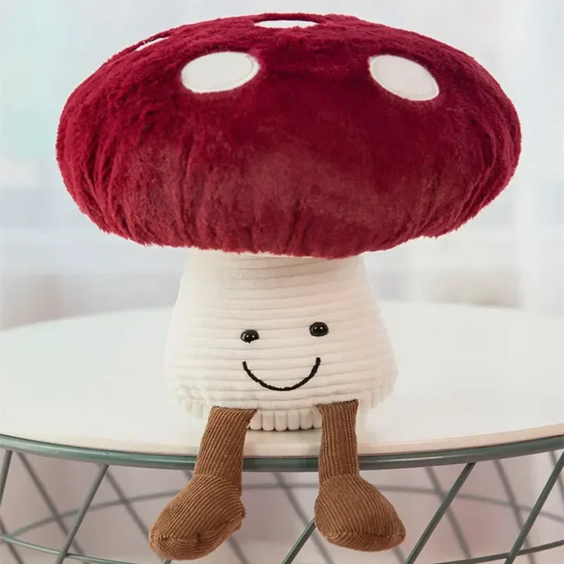 Plush toy mushroom with a red cap and white body on a blurred background