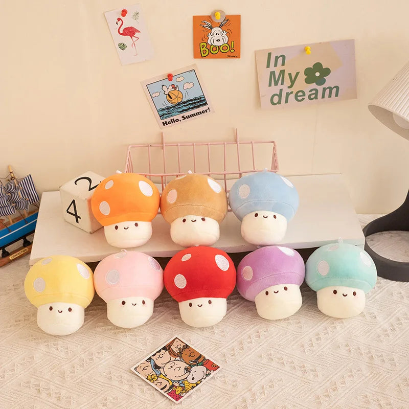 Colorful mushroom-shaped plush toys on a shelf with decorative items in the background.